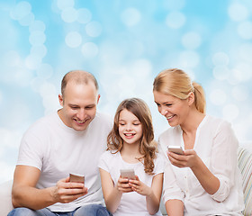 Image showing happy family with smartphones