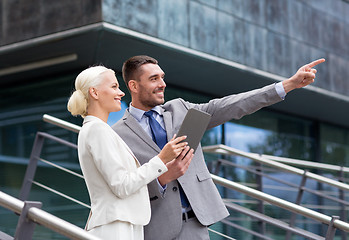 Image showing smiling businessmen with tablet pc outdoors