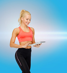 Image showing smiling sporty woman with tablet pc computer