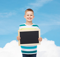 Image showing smiling little boy holding blank black chalkboard