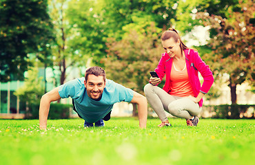 Image showing smiling man doing exercise outdoors