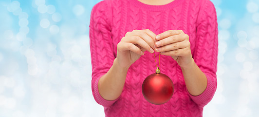 Image showing close up of woman in sweater with christmas ball