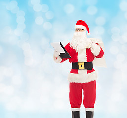 Image showing man in costume of santa claus with notepad and bag