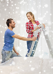 Image showing smiling couple with ladder at home