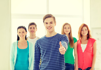 Image showing smiling students with teenage boy in front