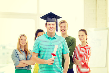 Image showing smiling male student with diploma and corner-cap