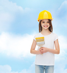 Image showing smiling little girl in helmet with paint brush