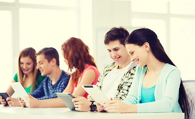 Image showing smiling students with tablet pc at school