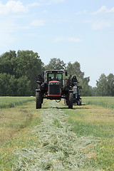 Image showing combine harvester on a wheat field with a blue sky