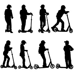 Image showing Set of silhouettes of children riding on scooters. Vector illust