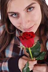 Image showing Beautiful girl smelling rose