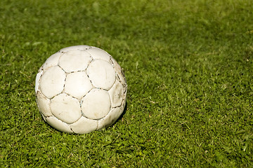 Image showing Old shabby ball on green grass