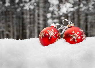 Image showing Two christmas balls in snow