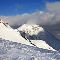 Image showing Off-piste slope and sunlit mountains at evening