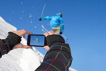 Image showing Photographed skiers jump with cell phone