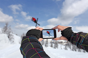 Image showing Photographed skiers jump with smart phone
