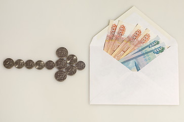 Image showing Coins arrow points to envelope with money