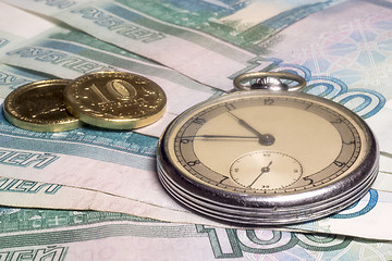 Image showing Vintage watch and coins on banknotes