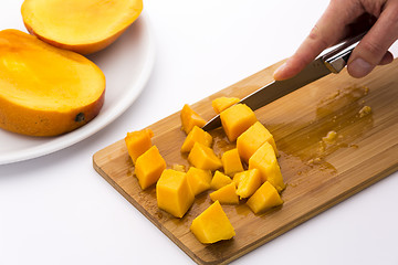 Image showing Ripe Mango Fruit Pulp Diced With A Kitchen Knife