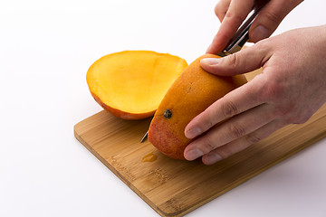 Image showing Third Of A Mango Sliced Off In A First Cut