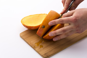 Image showing Second Cut Through A Mango Does Yield Three Slices