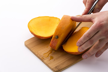 Image showing Trisecting A Mango Along Its Flat, Oblong Pip