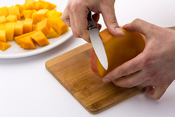 Image showing Peeling The Middle Mango Slice With The Fruit Pit
