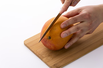 Image showing Knife In Position For A First Cut Through A Mango