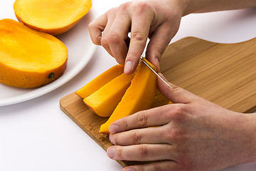 Image showing Peeling Away The Mango Skin From A Fruit Chip