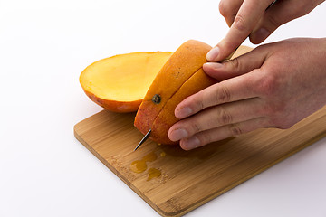 Image showing Mango Cut Into Thirds With A Second Section
