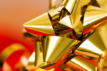 Image showing Festive golden bow on a blurred background. macro