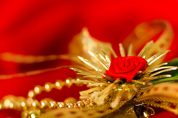 Image showing golden decoration on red fabric. macro