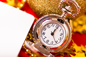 Image showing Christmas card. Silver vintage watch on a red background with go