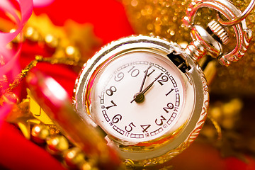 Image showing Christmas card. Silver vintage watch on a red background with go