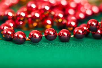 Image showing Christmas card. Red beads on green