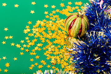 Image showing Christmas card. Stars and Christmas decorations on a green