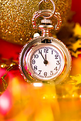 Image showing Christmas card. Silver vintage watch on a red background with go