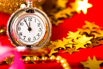 Image showing Christmas card. Silver vintage watch on a red background with go