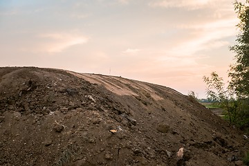 Image showing Large pile of soil under blue sky