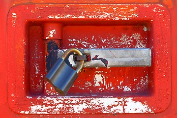 Image showing Old door locked with rusty padlock