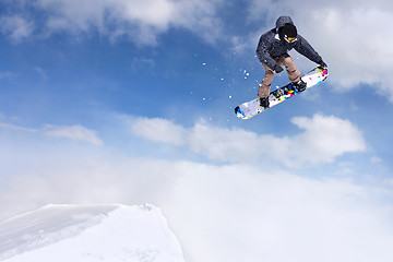 Image showing Jumping snowboarder