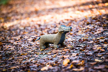 Image showing Soft toy dog is placed in autumn forest
