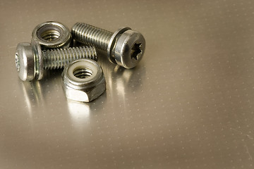 Image showing Bolts and nuts on metal surface

