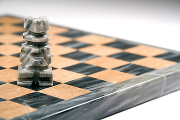 Image showing Closeup of marble chess piece and board