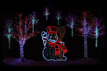Image showing Illuminated Christmas trees and Snowman