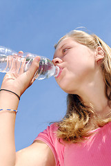 Image showing Young girl drinking water