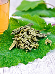Image showing Sage dried on fresh leaves with cup on board