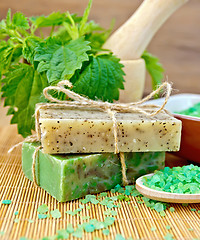 Image showing Soap homemade with nettles in mortar on board