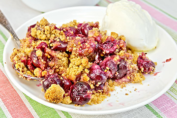 Image showing Crumble cherry in plate on tablecloth