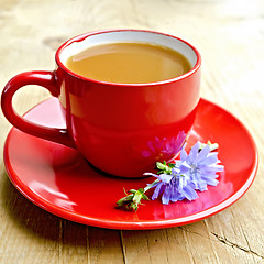 Image showing Chicory drink in red cup with flower on board